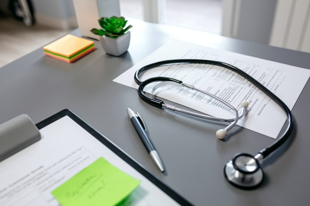 Doctor desk with stethoscope and documents