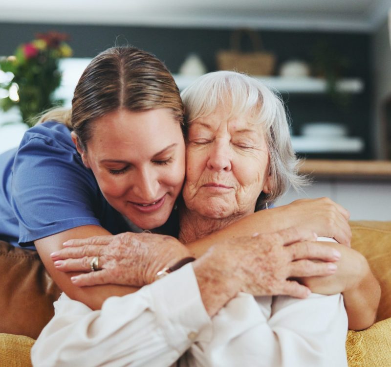 Happy woman, nurse and hug with senior patient in elderly care, love or nursing at retirement home